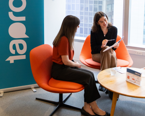 two people smiling in a coworking space